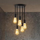 Ceiling light fixture with multiple illuminated bulbs on a textured wall background